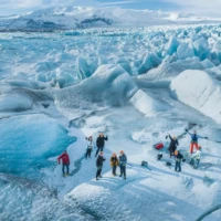 group of hikers, on the ice near a lake, seen from above