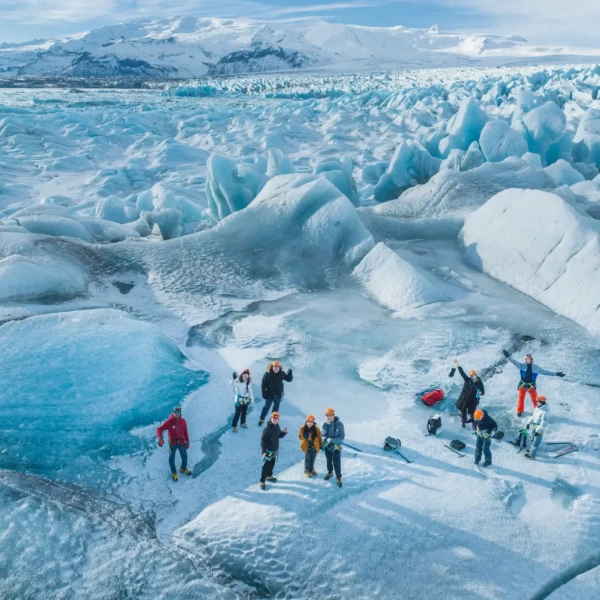 group of hikers, on the ice near a lake, seen from above