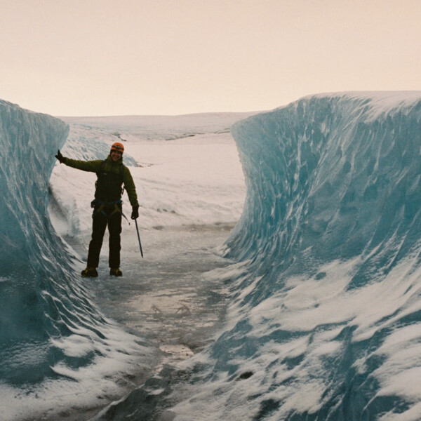 man posing in the middle of an ice-cut path