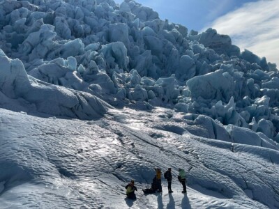 group, far away in the snow, backlighting