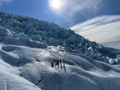 group, far away in the snow, backlighting