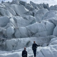 2 persons scrambling down the icefall