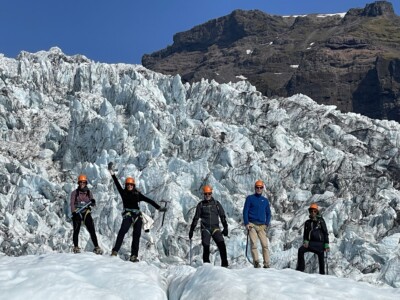 group from behind in front of icefall
